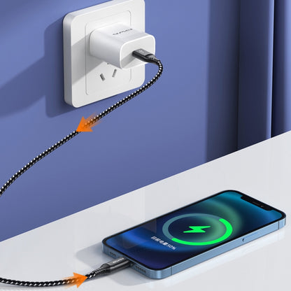 4-in-1 charging cable plugged into a wall outlet and smartphone