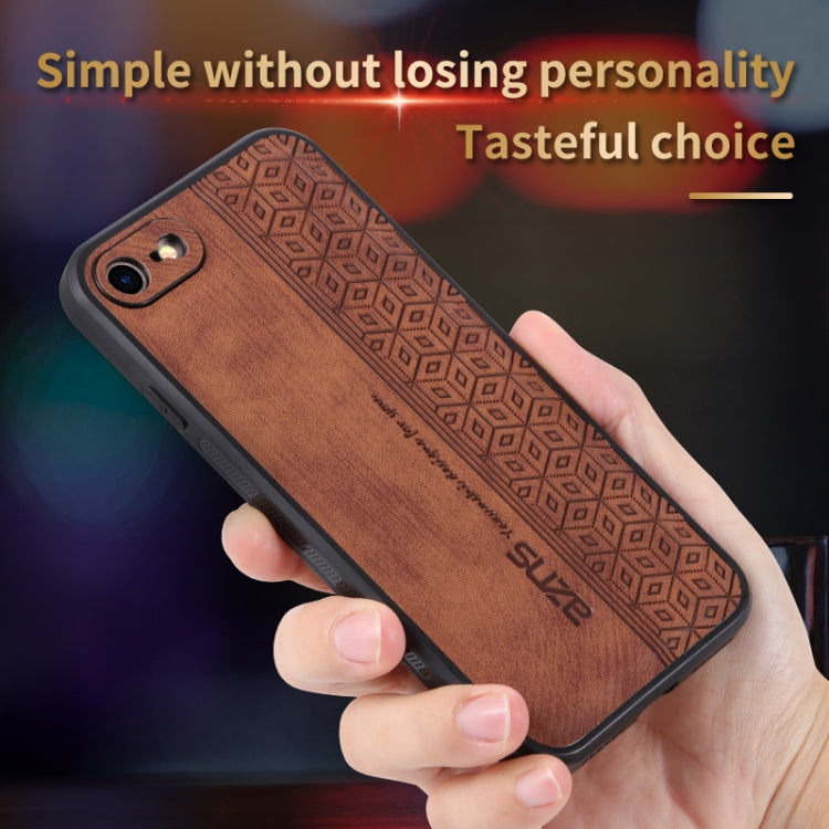 Brown geometric embossed phone case held in hand, with dual camera cutouts