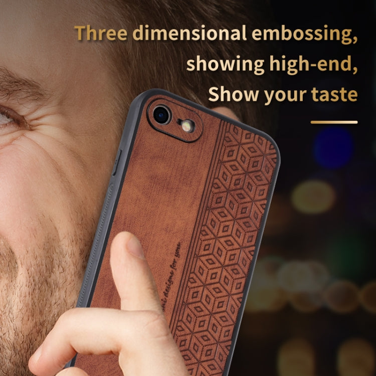 Brown geometric embossed phone case with dual camera cutouts, held in hand