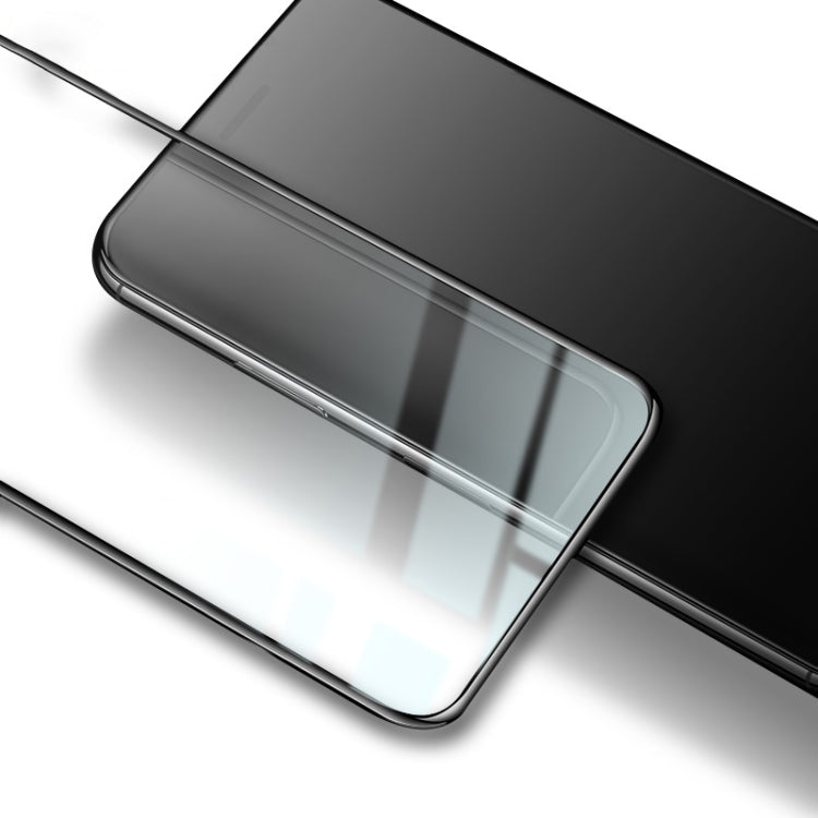 Tempered glass screen protector in place on phone screen, angled close-up