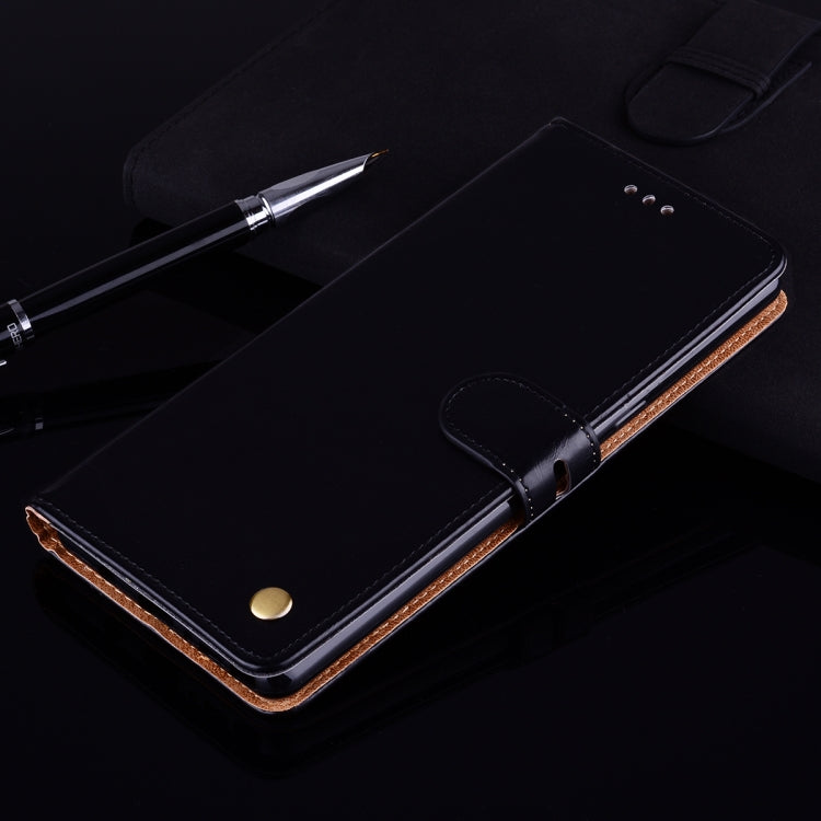 Black leather flip wallet case with magnetic clasp, stitched tan inner trim, stand-ready cover.