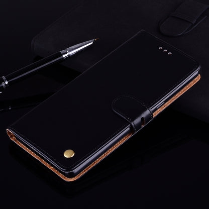 Black leather flip wallet case with magnetic clasp, stitched tan inner trim, stand-ready cover.