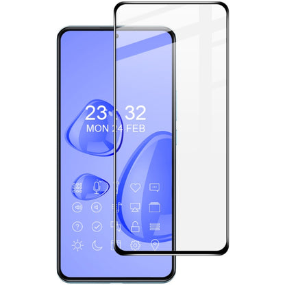 Clear full-screen tempered glass screen protector film aligned over smartphone