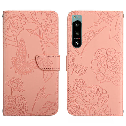Pink butterfly-embossed flip phone case with camera cutout and card slot
