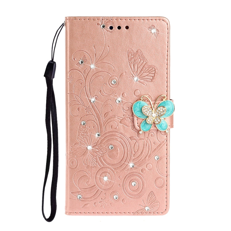 Rose gold leather phone wallet case with butterfly rhinestone embellishment and card holder