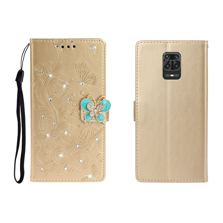 Gold embossed leather phone wallet case with butterfly rhinestone applique and wrist strap
