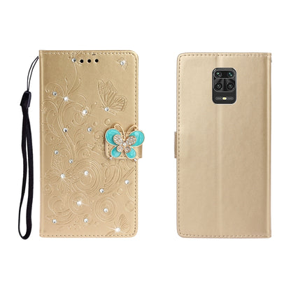 Gold embossed leather phone wallet case with butterfly rhinestone applique and wrist strap