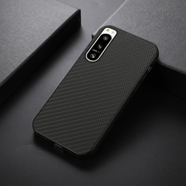 Black carbon fiber texture PU phone case, angled view with camera cutouts
