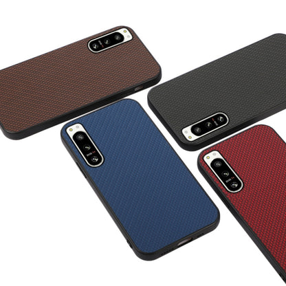 Carbon fiber texture PU phone cases in brown, blue, and red with camera cutouts