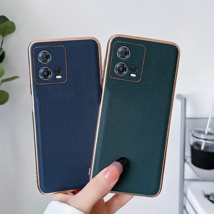 Blue and dark green leather phone cases side by side, held in a hand