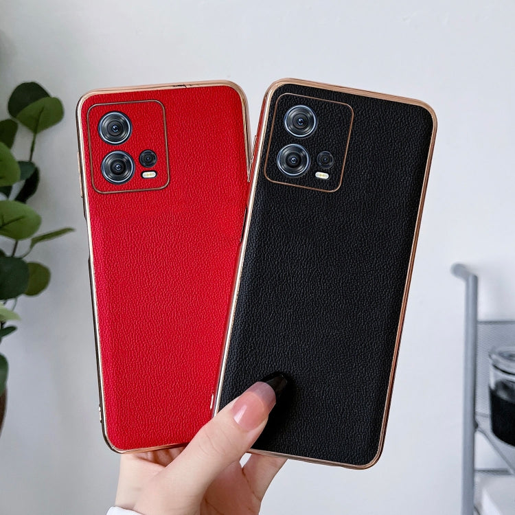 Black and red leather phone cases held together, camera cutouts visible