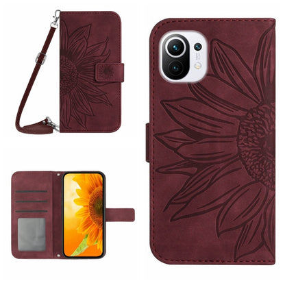 Burgundy flip phone case with sunflower pattern, card slots, and wrist lanyard