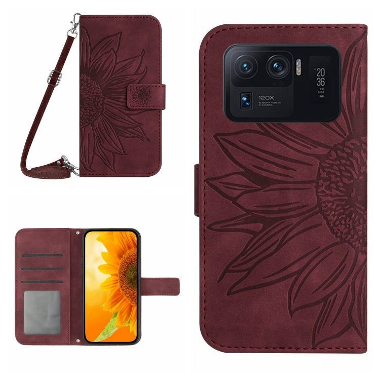 Wine red flip leather phone case with sunflower pattern, card slots, and wrist lanyard.