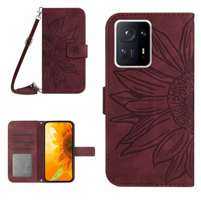 Wine red flip leather phone case with sunflower pattern, card slot, and wrist lanyard.