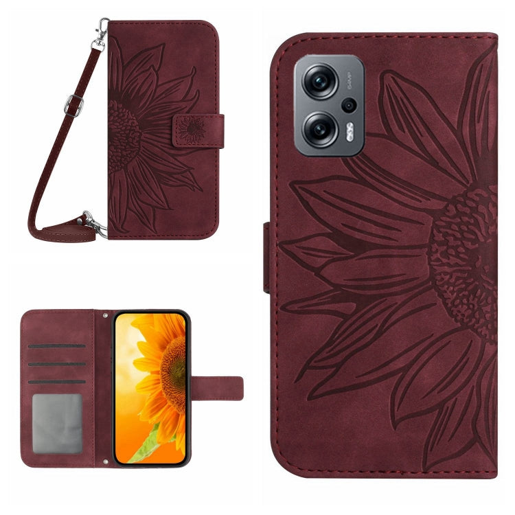 Burgundy flip leather phone case with sunflower embossing and card slots; lanyard attached