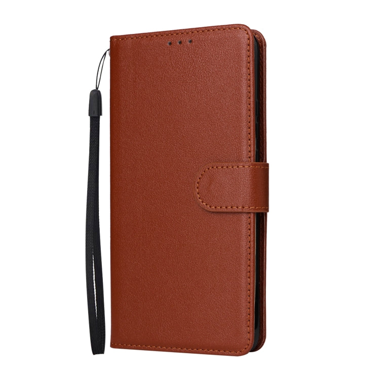 Brown leather flip phone case with front flap and wrist strap