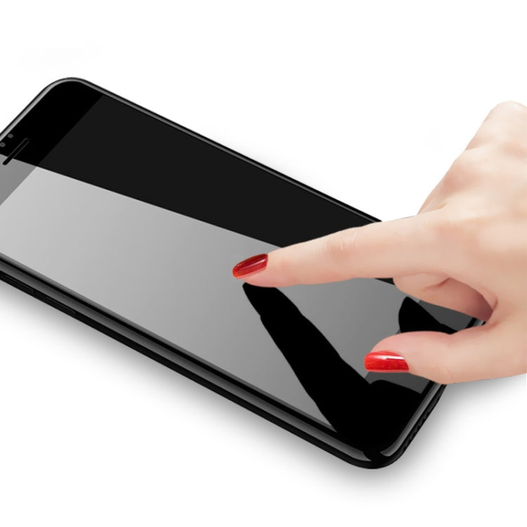 Tempered glass screen protector being applied to a phone screen by hand
