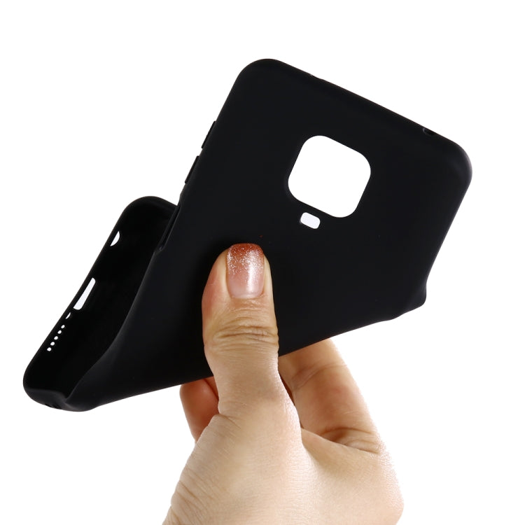 Black liquid silicone phone cover held in hand, showing camera cutout