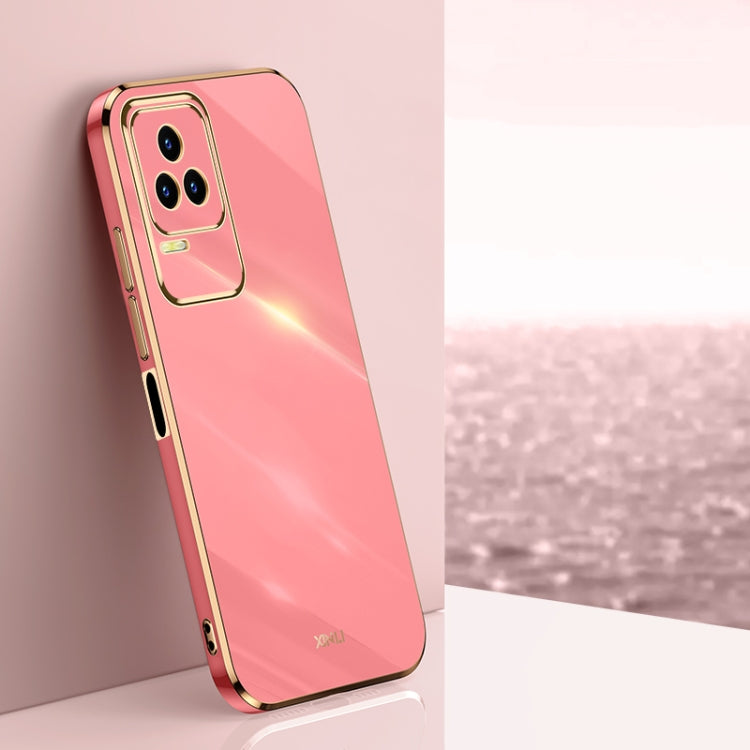 Coral pink TPU phone case with gold electroplated bumper and raised camera cutout.