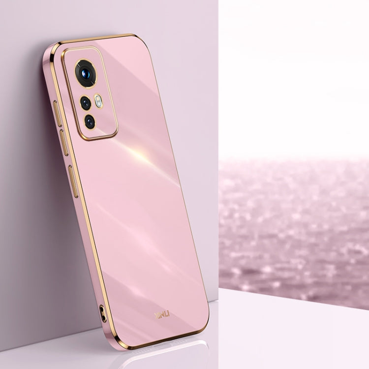 Light pink TPU phone case with gold electroplated bumper and raised camera cutout.