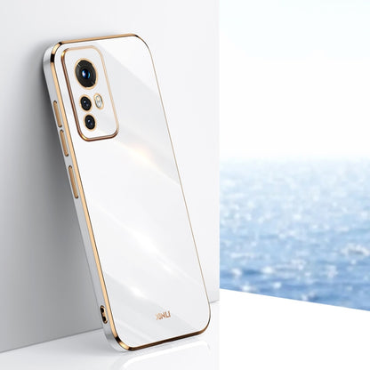 White electroplate TPU phone case with gold trim, raised camera bezel, and cutouts