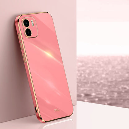 Coral pink TPU phone case with gold straight-edge frame and dual camera cutouts