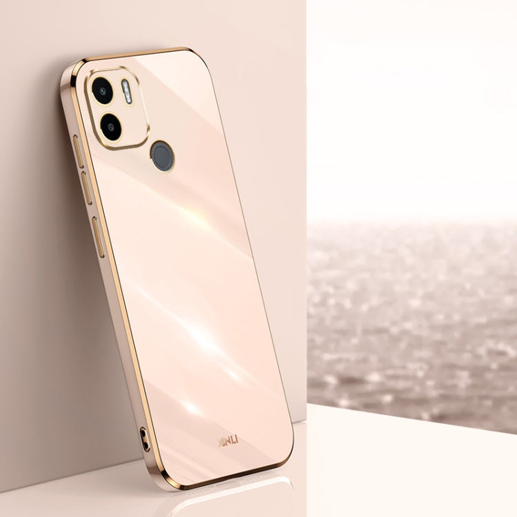 Light pink TPU phone case with gold-toned edges, raised camera and screen openings