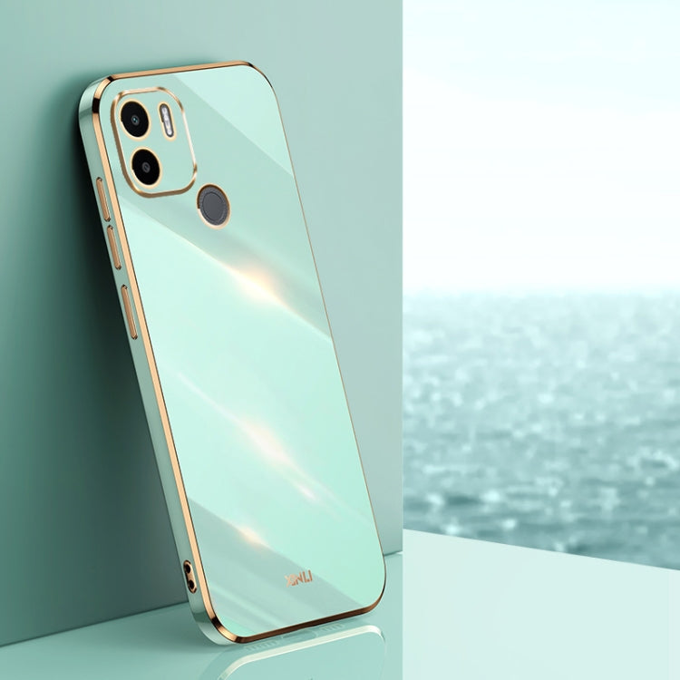 Mint blue TPU phone case with gold-toned edges, raised camera and screen openings
