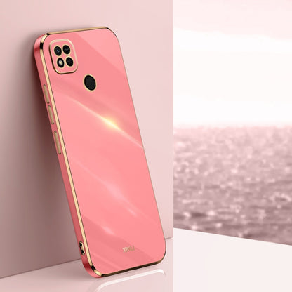 Coral pink TPU phone case with gold-toned edges, raised camera and screen openings