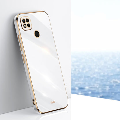 White TPU phone case with gold-toned edges, raised quad-camera and screen opening