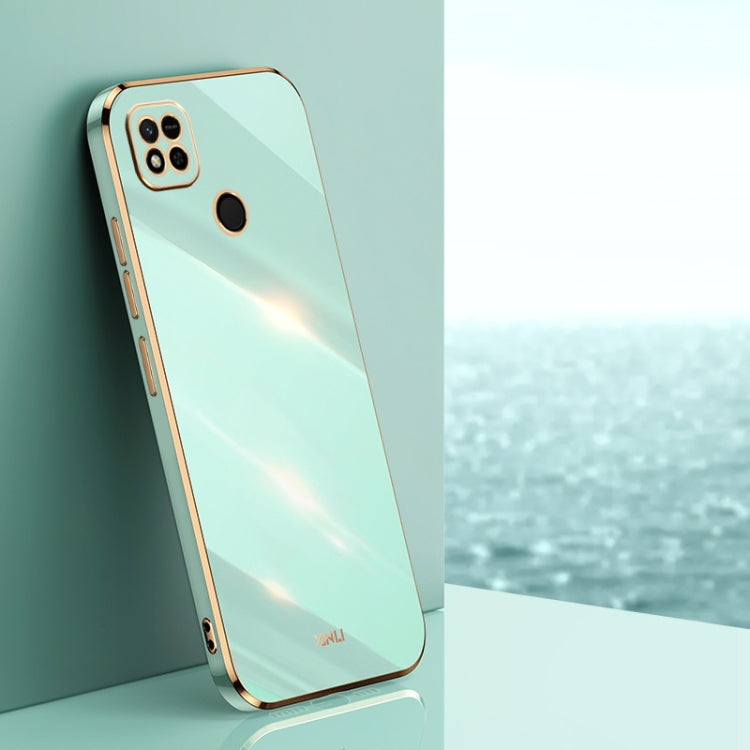 Mint blue TPU phone case with gold-toned edges, raised camera and screen openings