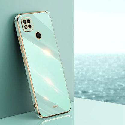 Mint blue TPU phone case with gold-toned edges, raised camera and screen openings