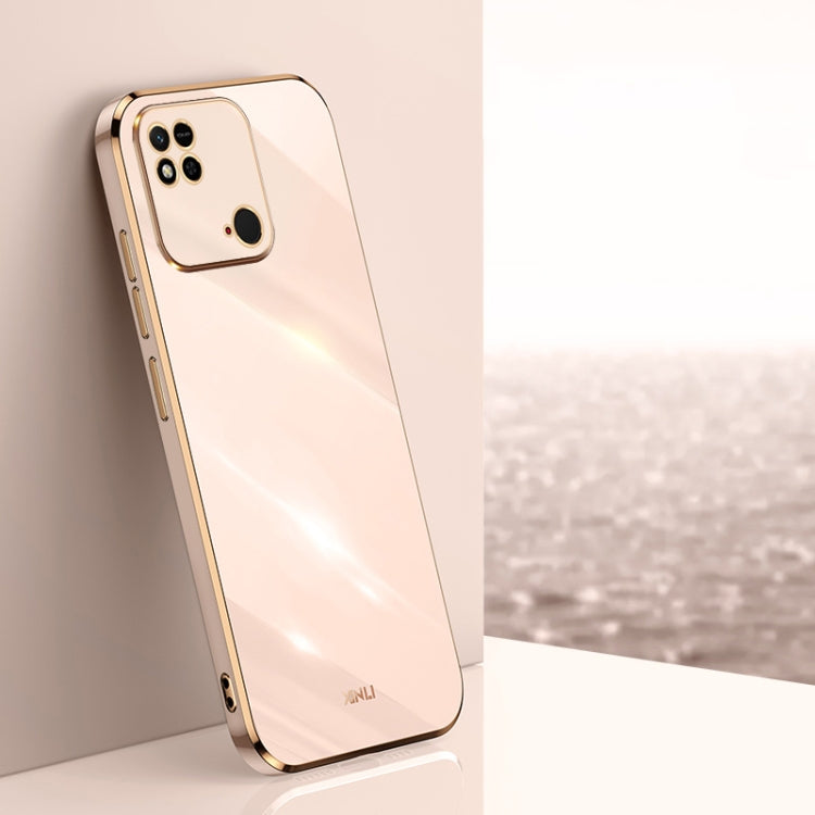 Light pink TPU phone case with gold-tone straight edges, camera cutouts, and raised rim