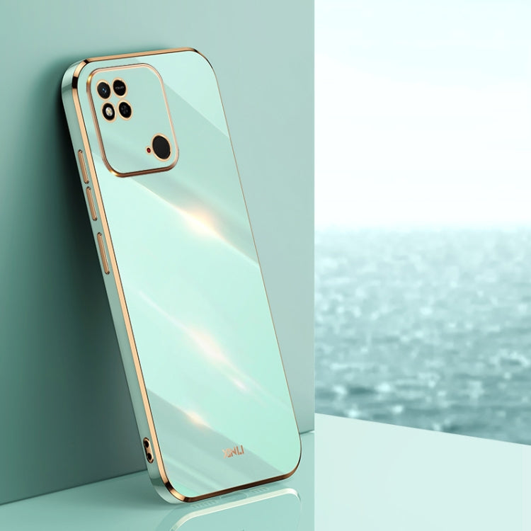 Mint green TPU phone case with gold-tone straight edges, camera cutouts, and rim