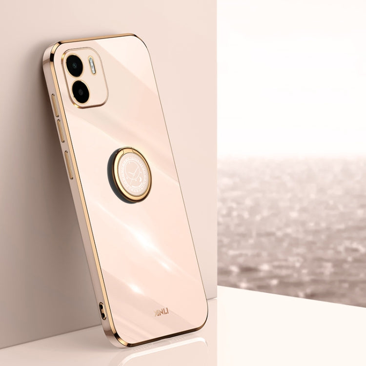 Light pink TPU phone case with ring holder, gold trim, and camera cutouts
