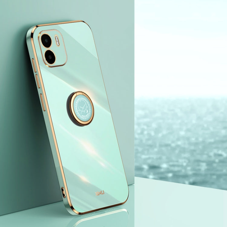 Mint green TPU phone case with ring holder, gold trim, and camera cutouts
