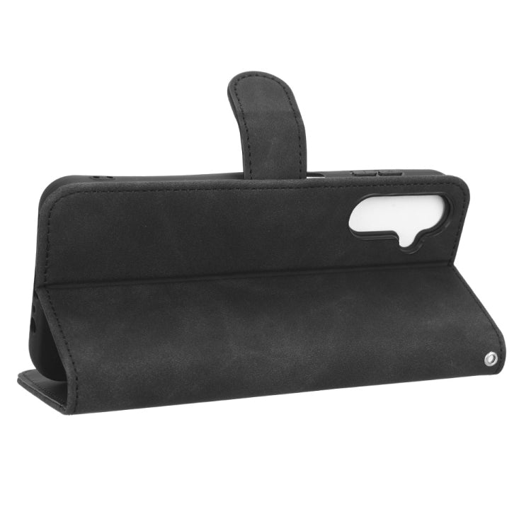 Black leather wallet-style phone case with horizontal stand flap and camera cutout