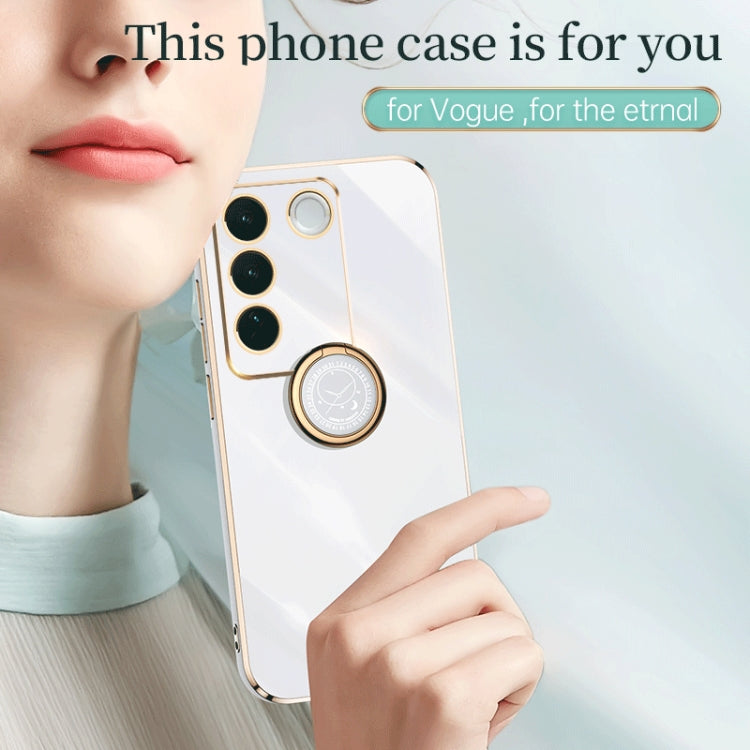 White phone case with gold trim and round ring holder near camera cutouts