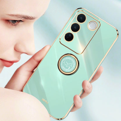 Teal phone case with gold trim and circular ring holder for hands-free grip