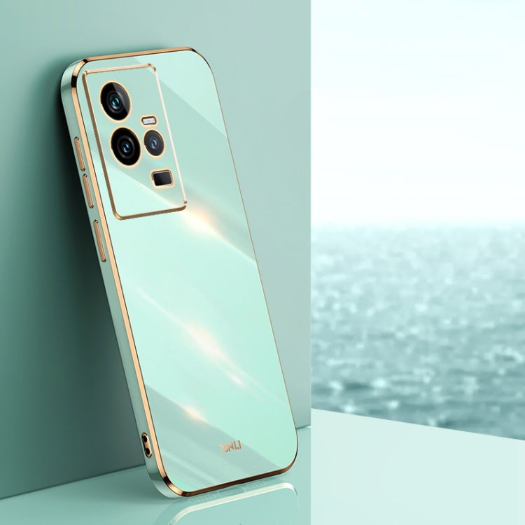 Mint green TPU phone case with gold electroplated trim and triple camera cutouts.