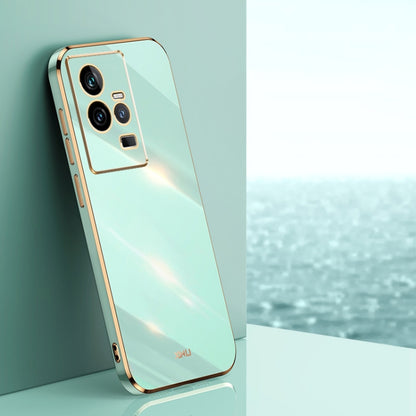 Mint green TPU phone case with gold electroplated trim and triple camera cutouts.