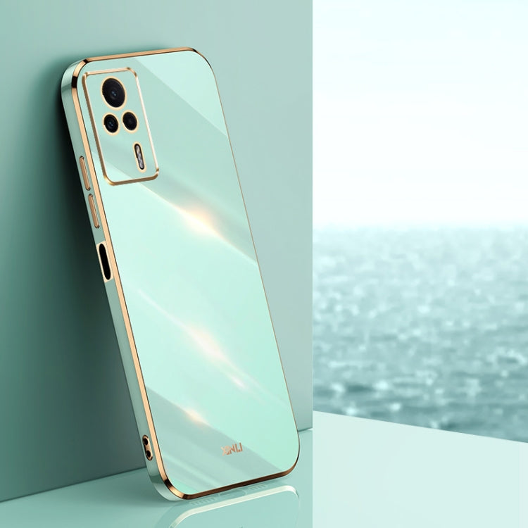 Mint blue electroplated TPU phone case with gold trim and camera cutouts