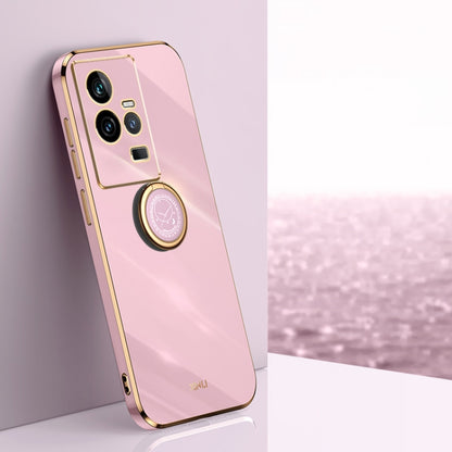 Pink TPU phone case with gold electroplate edges and ring holder near camera