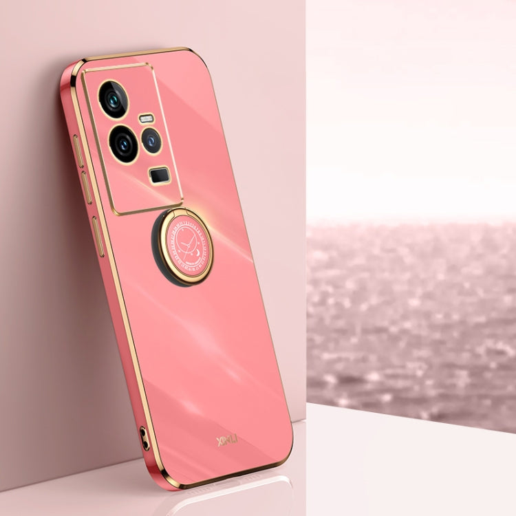 Coral red TPU phone case with gold electroplate edges and ring holder near camera