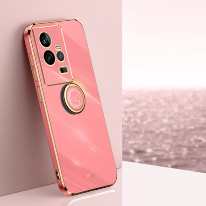 Coral red TPU phone case with gold electroplate edges and ring holder near camera