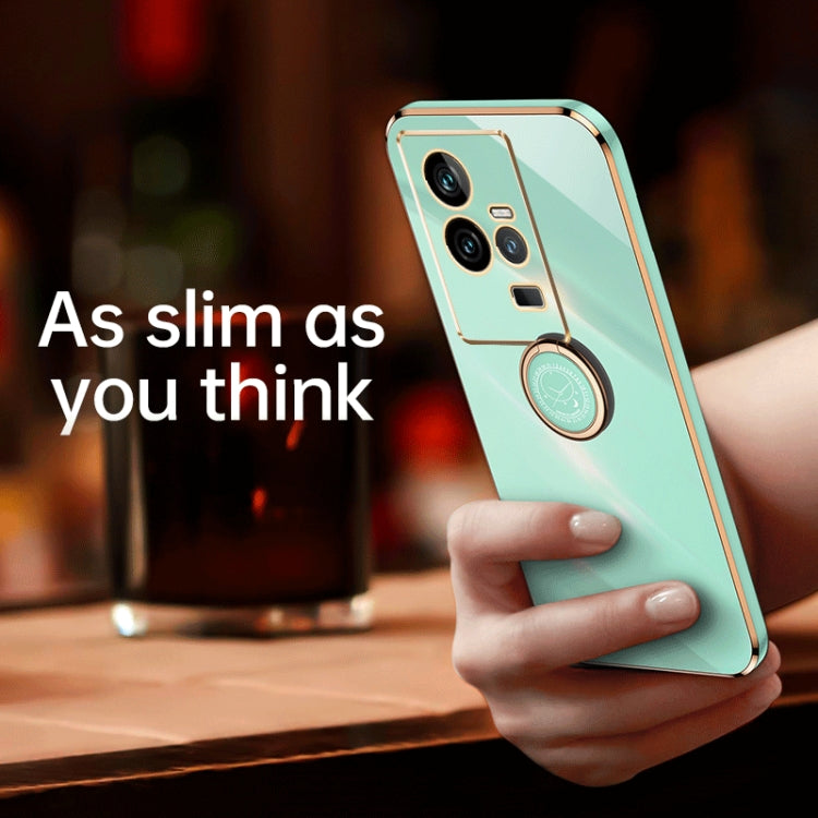 Mint blue TPU phone case with gold ring holder detail and raised camera protection