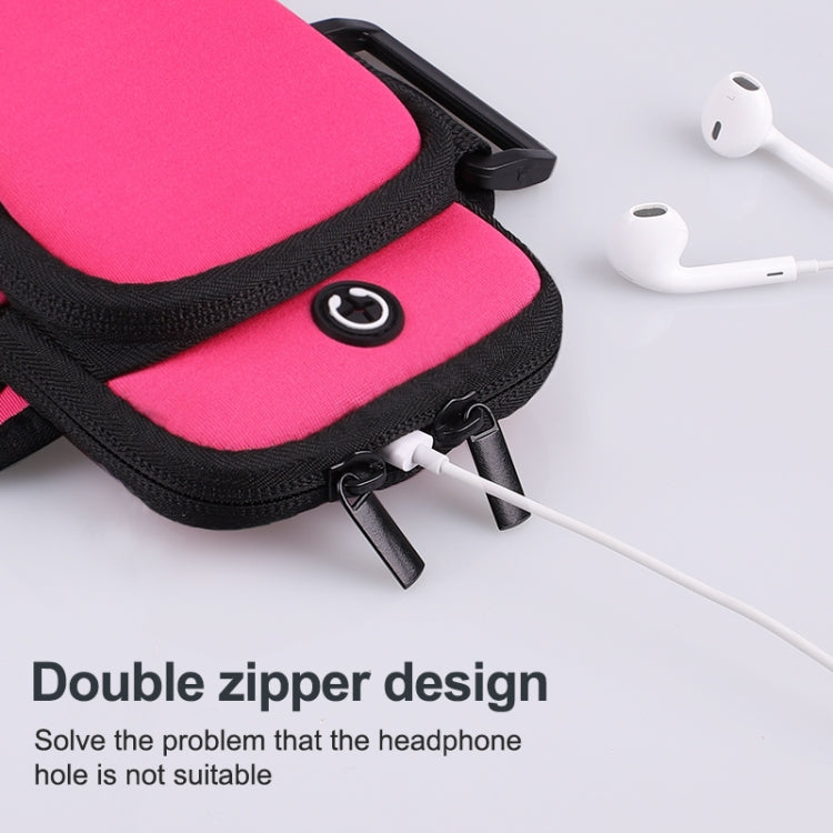 Pink sports arm bag close-up with double zipper and headphone cable