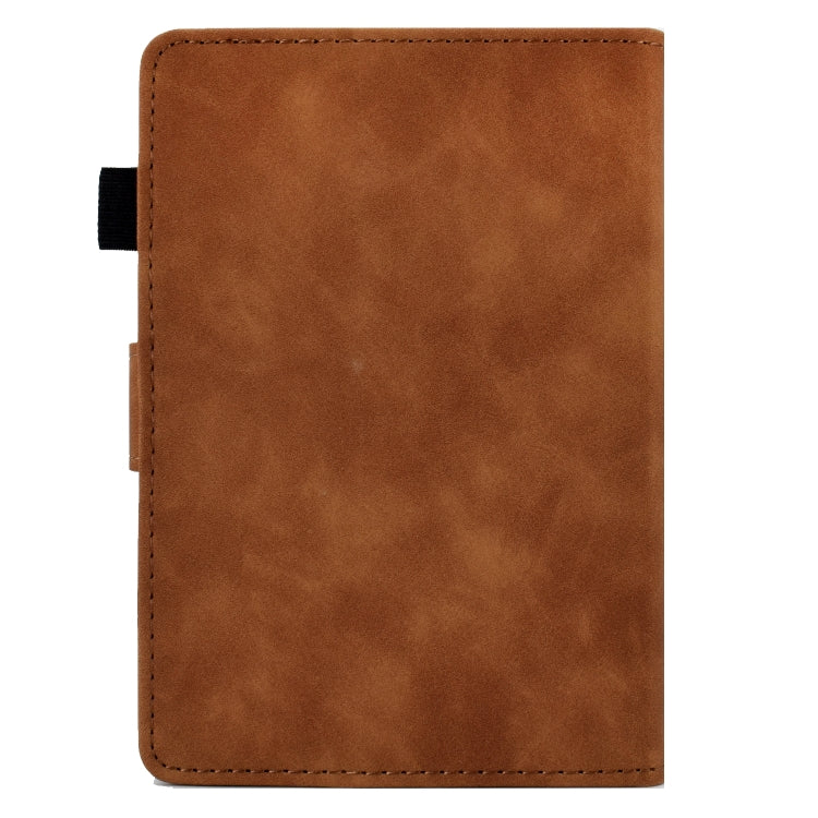 Brown leather tablet case back panel with stitched edges and opening for device