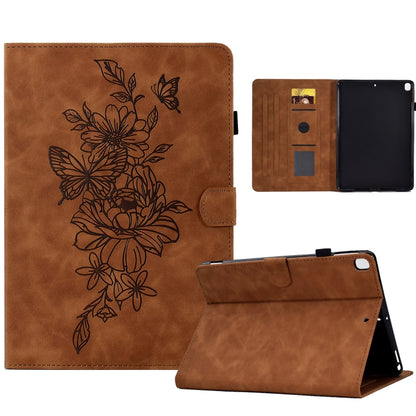 Brown leather tablet case with embossed floral butterfly design, open storage and stand