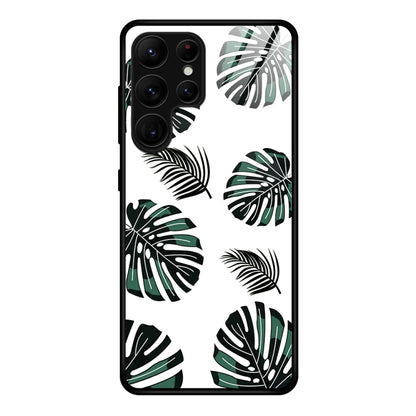 Glass phone case with green tropical leaf pattern and black phone frame cutouts